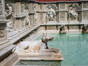 Statue of dog on the Gaia Fountain   in Siena